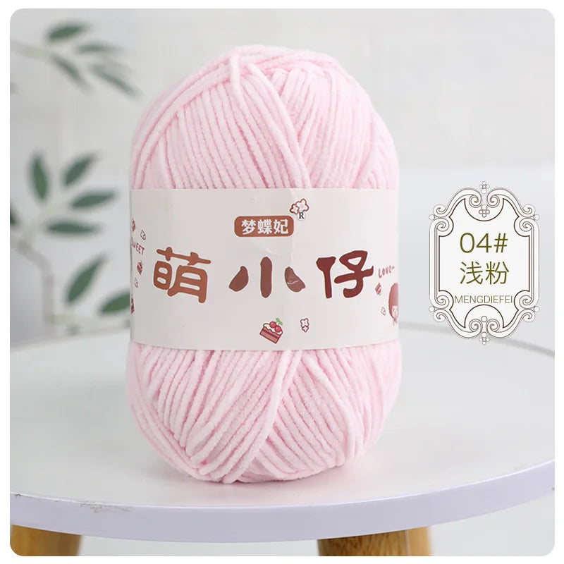 Pink chenille yarn skein with a white label and Chinese characters for knitting and crochet