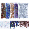 A collection of flat back resin rhinestones in various colors including gold, blue, purple, and silver.