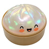 A round, translucent squishy toy shaped like a dumpling with cute facial features.