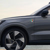 Side profile of a gray car showing a green, white, and red Mexican flag emblem on the fender.