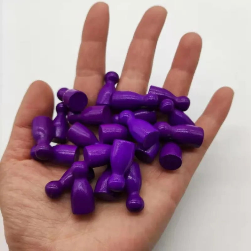 A hand holds a set of ten purple wooden chess pawns for board games.