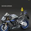 A silver and blue diecast model of a motorcycle showing the rear wheel suspension system.