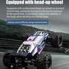 A purple and silver brushless 4WD monster truck RC car with large tires is shown in motion on a track.