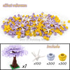 A collection of purple and yellow building blocks used to create a cherry blossom tree model.