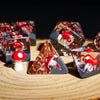 A close-up of a set of translucent dice shaped like mushrooms scattered on a wooden surface.