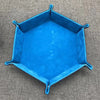 A bright blue foldable PU leather hexagonal dice tray used as a tabletop game organizer.
