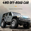 A gray 1:18 scale 4WD off-road RC Jeep is shown driving over rough terrain.