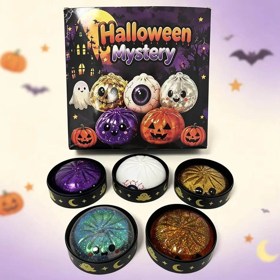 A box of Halloween Mystery squishy fidget toys featuring glitter pumpkins, eyeballs, and skulls, with several loose balls dis