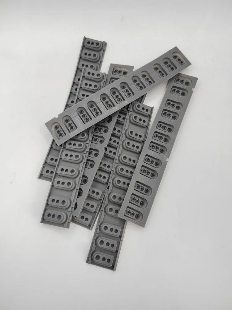A collection of gray replacement keyboard contact strips for Yamaha digital pianos, laid out on a white surface.