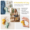 Handcrafted crochet dinosaur charm keychain in yellow and green colors