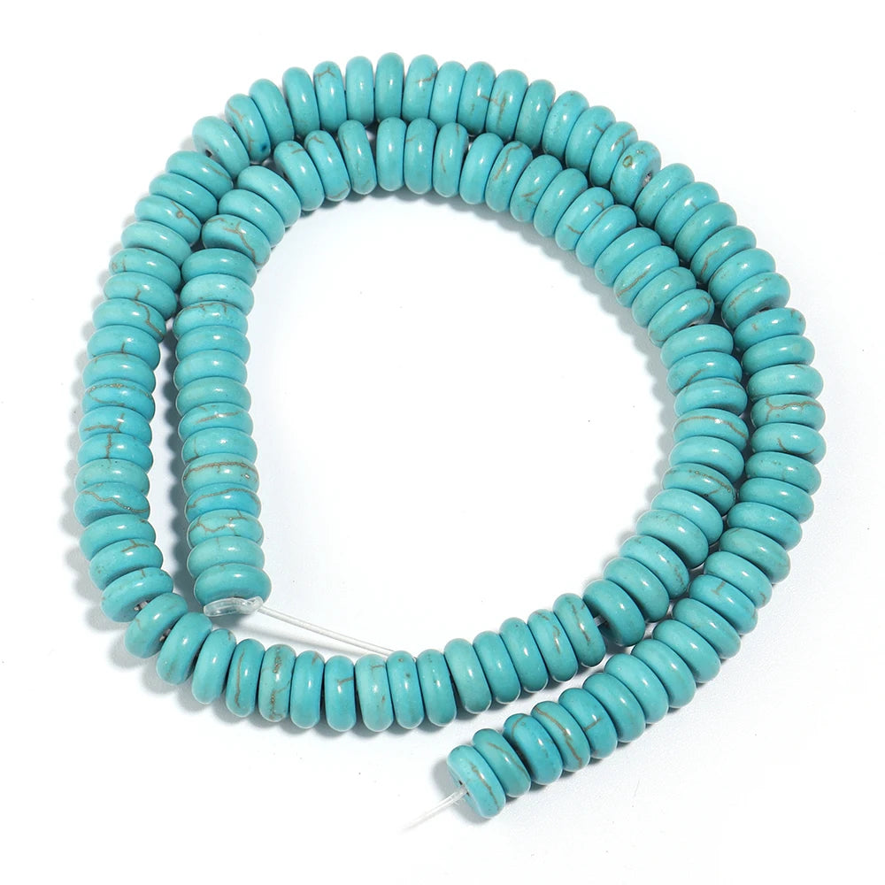 A strand of light blue turquoise stone beads coiled into a circular shape.
