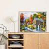 Diamond painting kit featuring a scenic forest house with autumn foliage and flowing water.