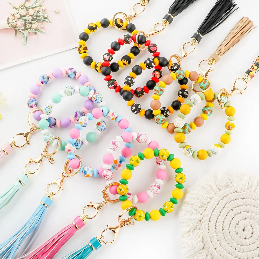 A collection of 117 mixed bead and rhinestone jewelry making set featuring colorful beads on gold-toned strings.