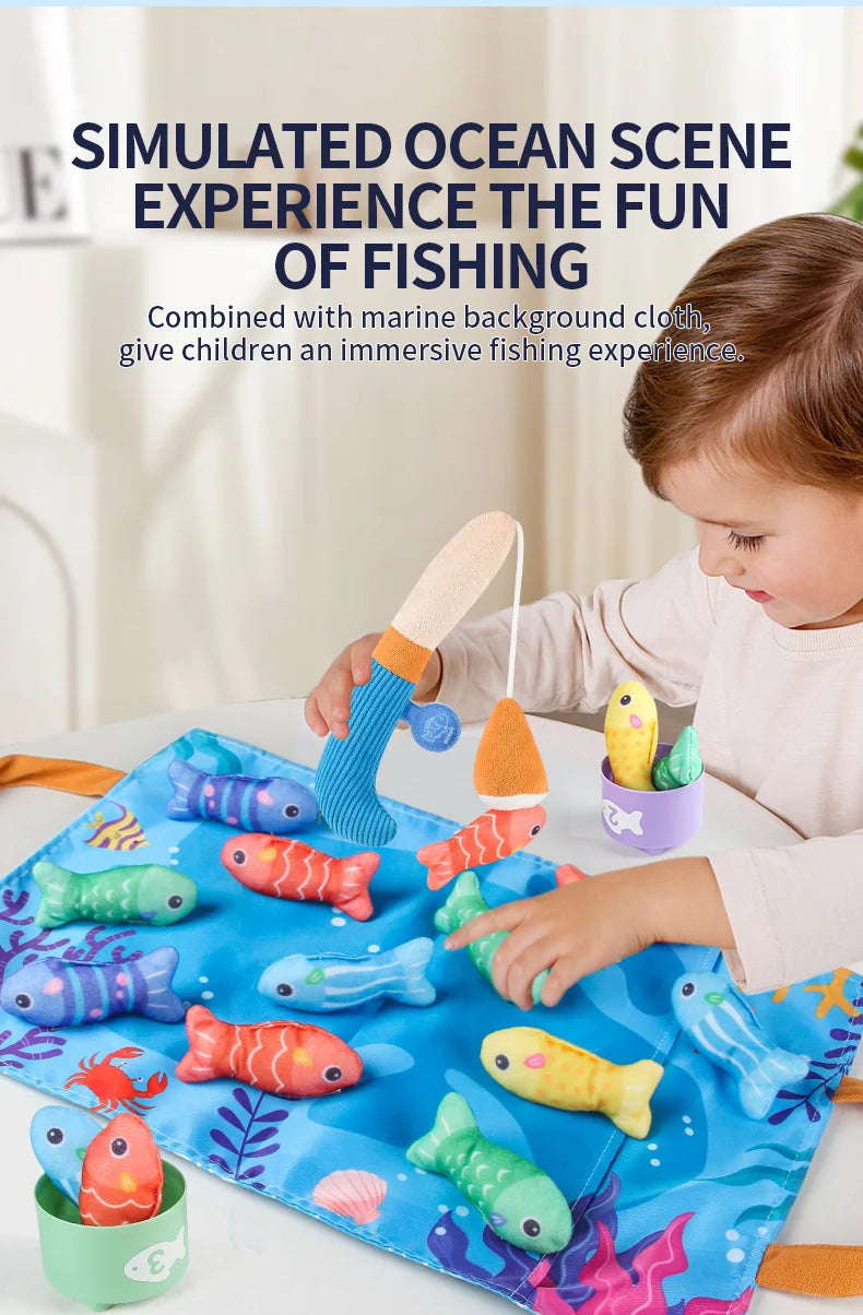 A child is playing with a simulated ocean scene fishing game featuring colorful fish and sorting cups on a blue cloth.