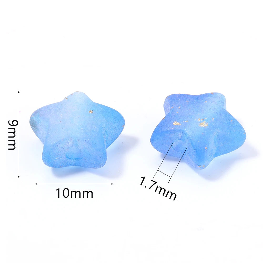 A light blue transparent star acrylic bead with gold accents, shown next to a measurement scale.