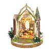A detailed DIY wooden floral book nook kit featuring an arched window and decorative elements with LED lighting.