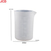 A white flexible silicone measuring cup with volume markings, shown next to its dimensions.