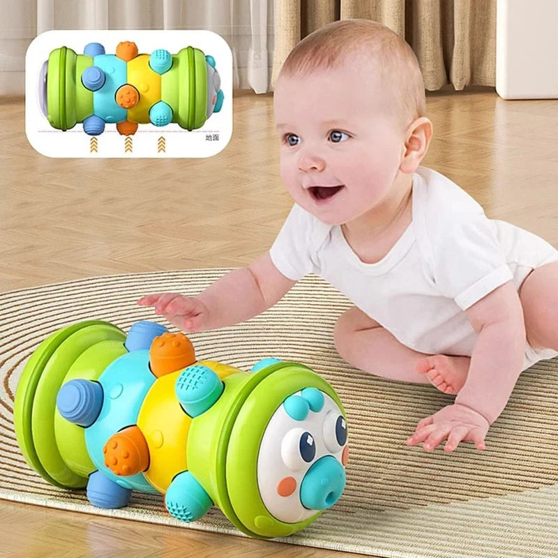 A baby is playing with a colorful Montessori crawling roller toy on a mat.