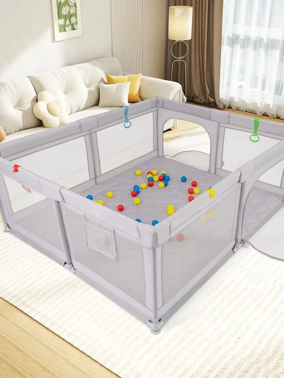 A large gray baby playpen with a breathable mesh enclosure and colorful balls inside