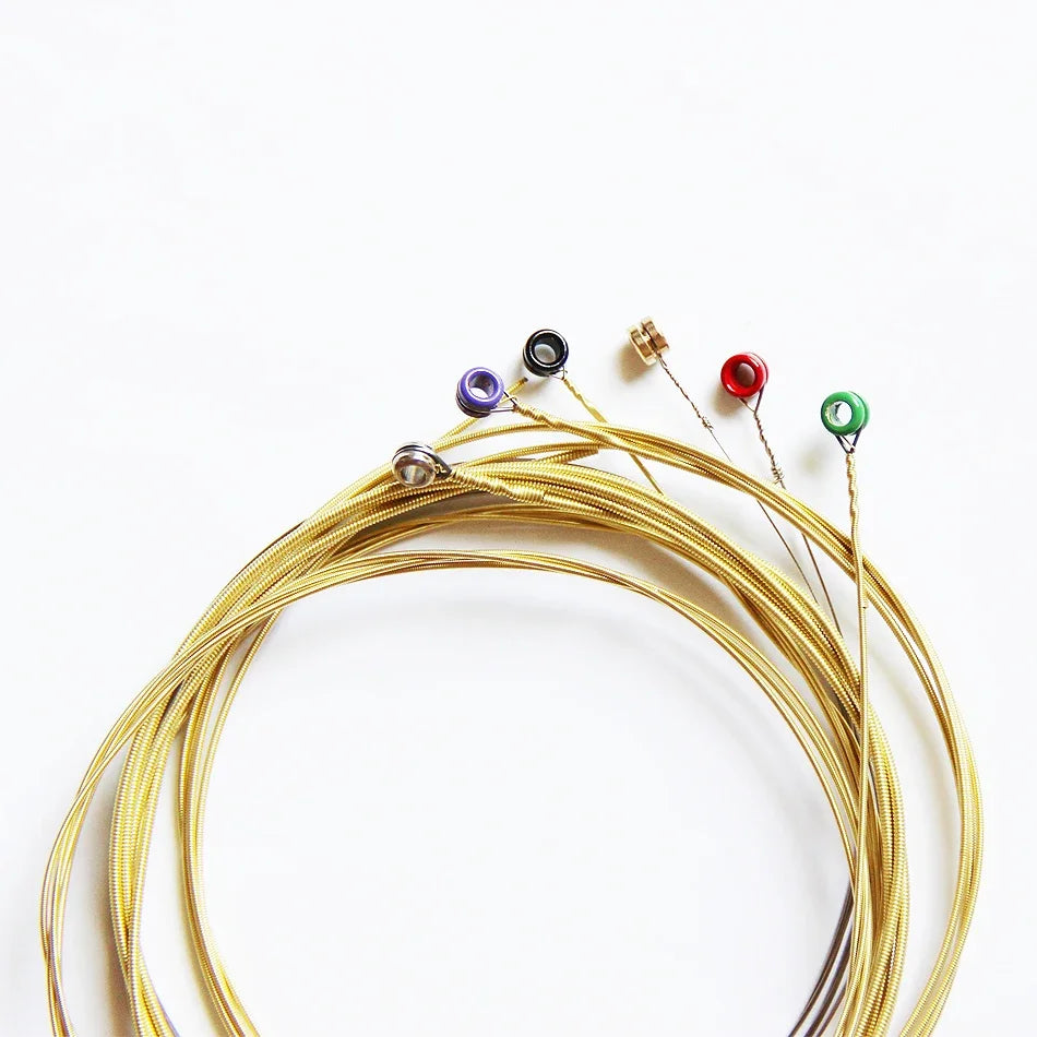A set of bronze acoustic guitar strings with various colored tuning pegs arranged in a semi-circle.