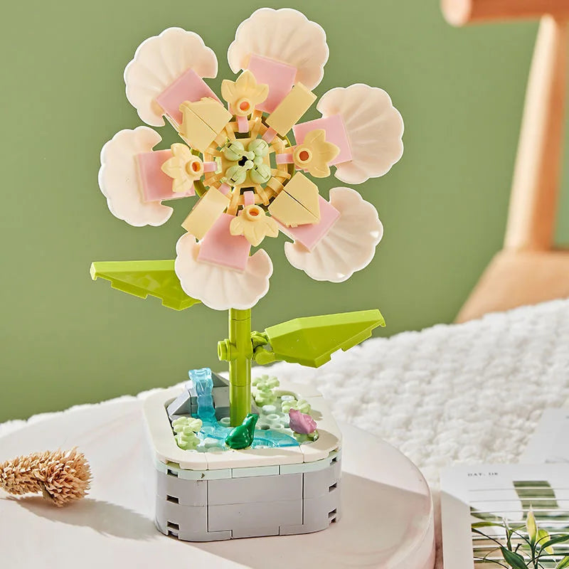 A colorful building block bouquet set featuring pink and yellow rose flowers on a green stem.