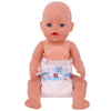 A pink baby doll with blue eyes wearing a white feeding bib and sitting down.