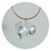 A clear glass charm shaped like a cat is suspended from a gold-colored cord.