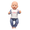 A baby doll wearing a unicorn pajama set with pink floral details.