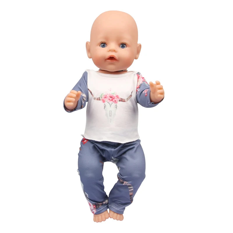 A baby doll wearing a unicorn pajama set with pink floral details.