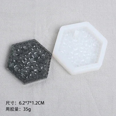 A set of flexible silicone resin molds in black and white, including a hexagonal mold and a clear mold.
