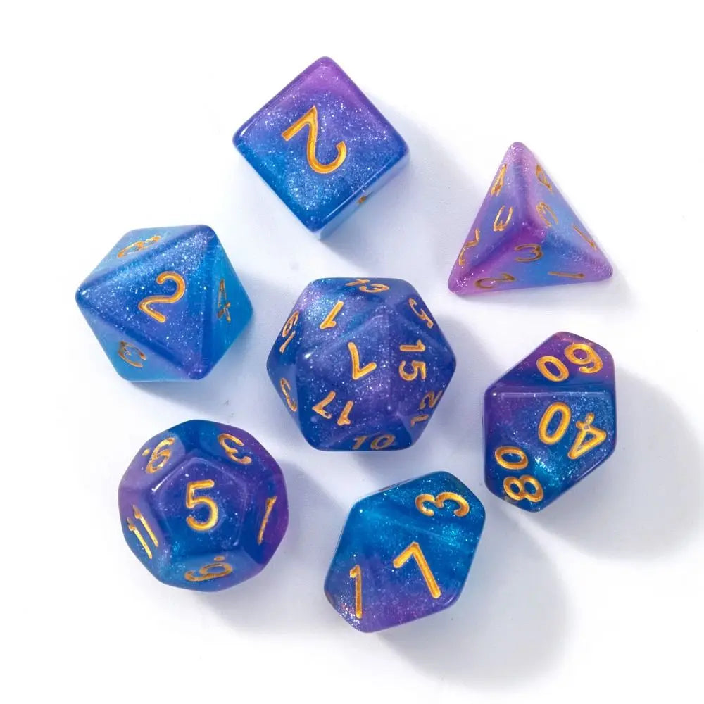 A collection of seven polyhedral acrylic dice in various shades of blue and purple scattered on a white surface.