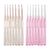 A set of seven aluminum crochet hooks with color-coded pink and clear handles.