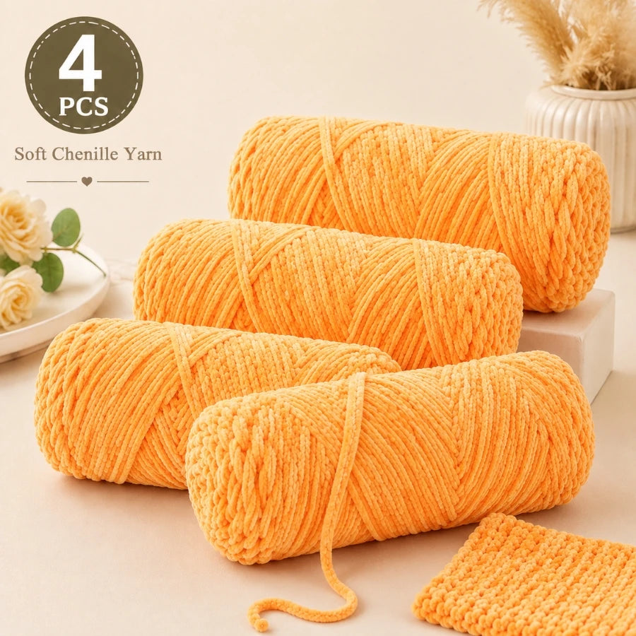Four orange balls of soft chenille yarn for crochet and knitting projects