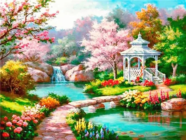 A vibrant diamond painting depicts a scenic forest with pink blossoms, lush greenery, and a flowing stream.