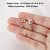 A hand displays various mixed color acrylic spacer beads for jewelry making including round and floral shapes
