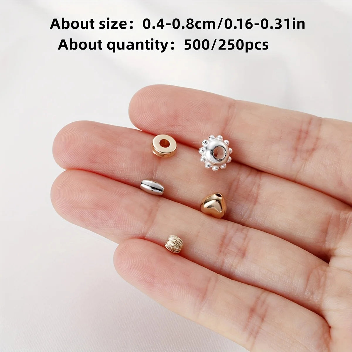 A hand displays various mixed color acrylic spacer beads for jewelry making including round and floral shapes