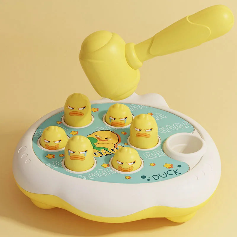 A yellow Montessori animal hammer toy with a duck head is shown on a light-colored surface.