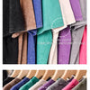 A close-up of several loose, colorful men's retro washed cotton t-shirts displayed on a hanger.