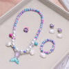 A set of five mermaid pearl jewelry pieces including a necklace and earrings displayed on a light background.