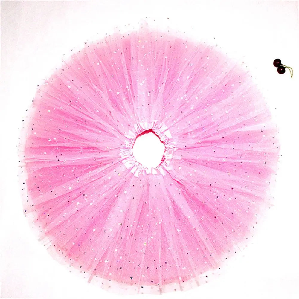 A pink sparkling tutu dress for girls with a full, radiating skirt and a small black accessory.