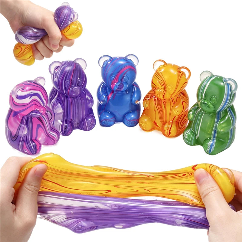 Colorful gummy bear squeeze toys in various colors and shapes being held by a hand.