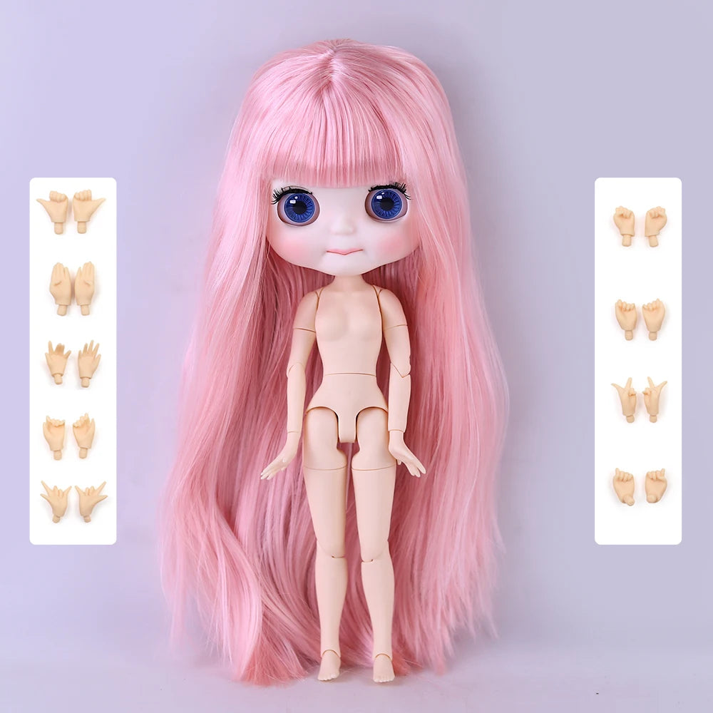 A pink Blyth fashion doll with long hair and large blue eyes is displayed against a light gray background.