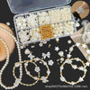 A box containing pearl beads, stringing materials, and assorted jewelry components for making necklaces and bracelets.