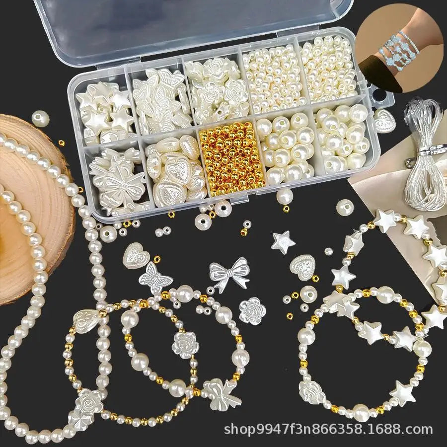 A box containing pearl beads, stringing materials, and assorted jewelry components for making necklaces and bracelets.