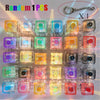 A collection of 16 colorful keyboard keychains or fidget toys with LED lights displayed in a grid.