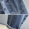 Close-up of blue denim jeans showing the texture and pocket detail.