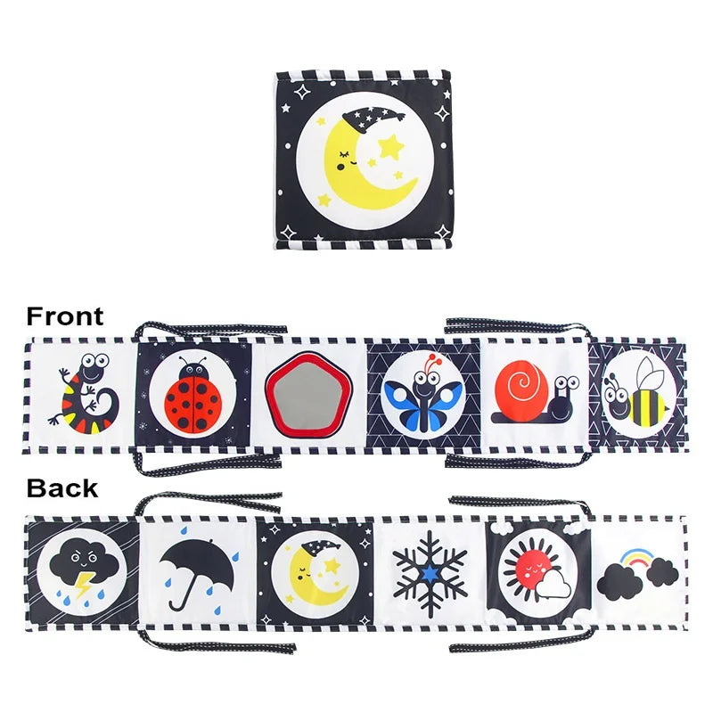 Front and back views of a soft sensory cloth book for babies featuring moon, stars, and other celestial elements.