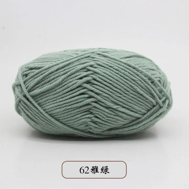 A ball of soft, light green pre-dyed milk cotton yarn with 62 strands.