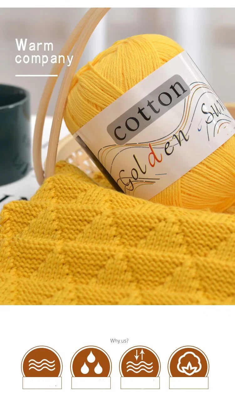A ball of bright yellow cotton knitting yarn next to a finished knitted garment.