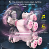 A pink remote control stunt robot dog with 8 wheels is shown performing a dance on a dark surface.